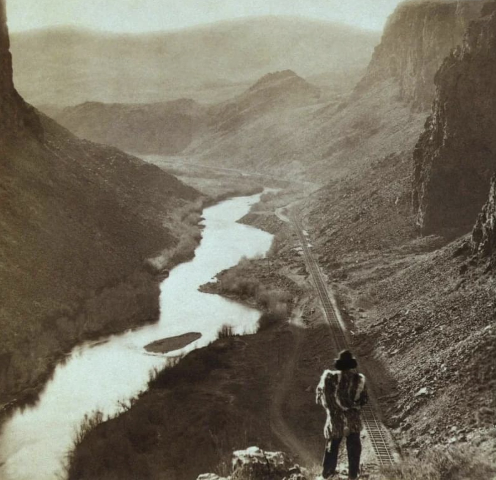 A native American man looking over the newly completed transcontinental railroad in Nevada, 1869 